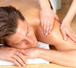 Happy man getting massage at spa