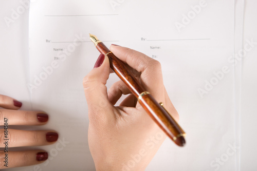 Photo: woman signing a contract woman signing a contract