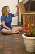 Woman painting a Chair Outdoors