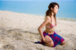 woman kneeling on the beach