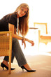 Beautiful young woman sitting in chair