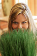 Beautiful young woman looking over green grass.