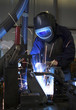 Welding a car part in a factory Welding a car part in a factory