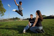 Photo: Three young friends outdoors, one of them jumping. Three young friends outdoors, one of them jumping.