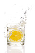 Lemon splashing into martini glass