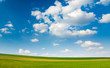 Large piece of land and blue cloudy sky Large piece of land and blue cloudy sky