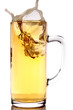 Ice splashing into a mug of beer