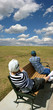 Photo: Couple in the field enjoying the view Couple in the field enjoying the view