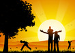 Happy family at sunset under a tree