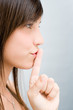 Girl putting a finger to her lips