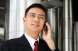 Photo: Young asian executive talking on handphone Young asian executive talking on handphone