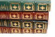 Four colored books laying on each other Four colored books laying on each other