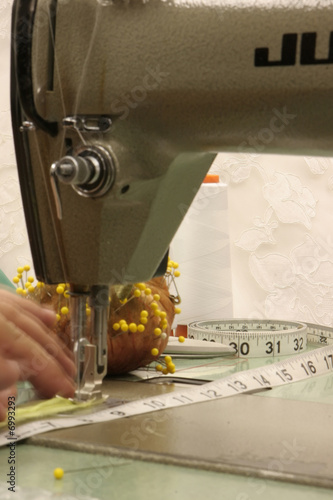 Photo: hands working a sewing machine hands working a sewing machine