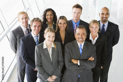 Photo: Group of co-workers standing in office space smiling ( Group of co-workers standing in office space smiling (