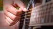 Person playing acoustic guitar