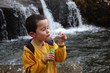 Young boy blowing bubbles