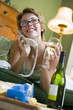 Woman at home on phone drinking wine