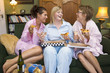 3 girlfriends at home eating pizza