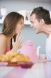 Couple arguing at table