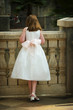 little flower girl at wedding trying to see the bride