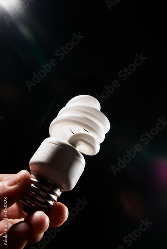 Photo: Human hand holding cfl lightbulb Human hand holding cfl lightbulb