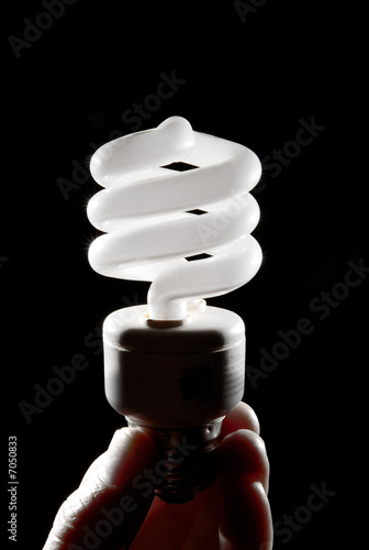 Photo: Human hand holding cfl lightbulb vertically Human hand holding cfl lightbulb vertically
