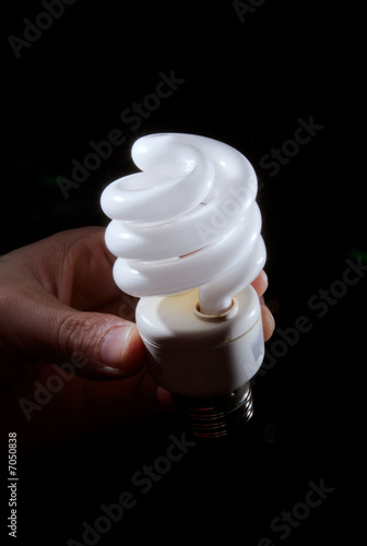 Photo: Human hand holding cfl lightbulb Human hand holding cfl lightbulb
