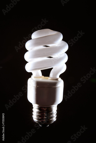 Photo: Cfl fluorescent lightbulb on dark background Cfl fluorescent lightbulb on dark background