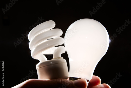 Photo: cfl and incandescent lightbulbs on black cfl and incandescent lightbulbs on black