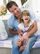 Father and daughter relaxing in garden