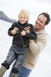 Father playing with son at beach