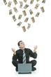 Money raining down on a businessman with a laptop Money raining down on a businessman with a laptop