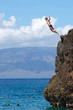 Middle age male Jumping off Black Rock in Maui Hawaii