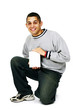 Young Man Kneeling and Demonstrating Blank DVD case