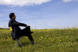 Businessman sitting in a yellow chair