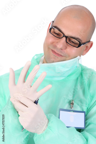 Photo: surgeon putting medical gloves on surgeon putting medical gloves on