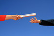 hands passing baton hands passing baton