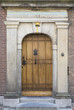 Oak door with nails in stone gate of old hospital: 1644
