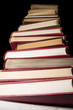 Stack of encyclopedia books over black background