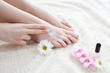 Woman applying cream on her feet