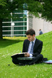 business man with laptop working in the park