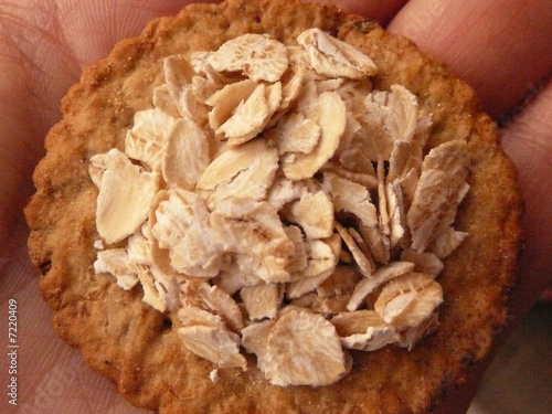 Photo: cracker with oats on a hand cracker with oats on a hand
