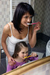 Mother and daughter brushing teeth