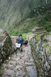 People walking down an ancient ruin on the inca trail People walking down an ancient ruin on the inca trail