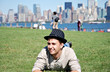 Young boy lying on green grass to relax