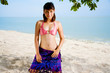 sweet smiling woman kneeling on the beach