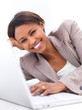 Photo: Business woman lying down by laptop Business woman lying down by laptop