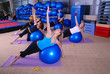 Beautiful girls meditating in fitness club