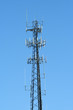Antenna radio tower against blue sky