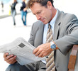 Photo: Business man reading newspaper outside Business man reading newspaper outside